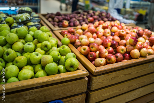 Ripe apple in wooden box Fresh striped apples in wooden box with straw