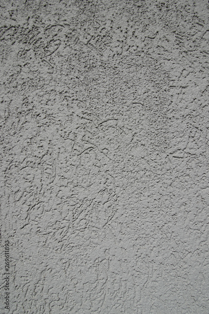 Gray plastered wall in sunlight. Modern building materials for e Gray plastered wall in sunlight. Modern building materials for e