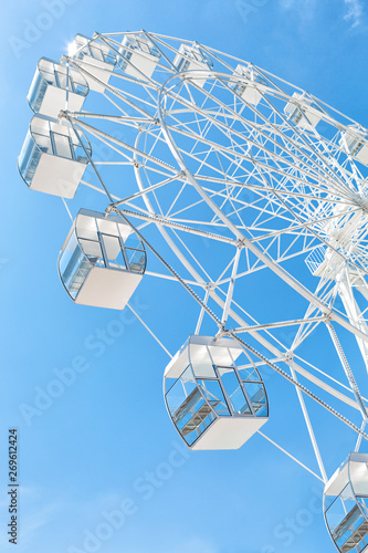 White Ferris wheel against clear blue sky