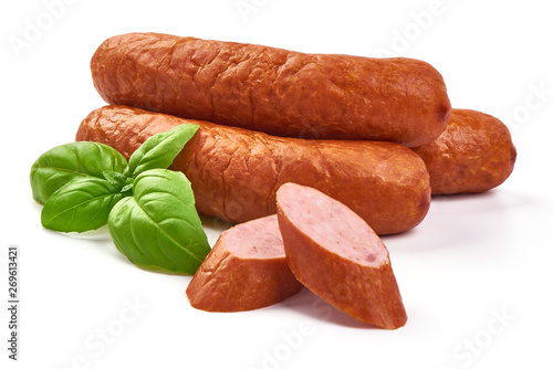 Smoked pork sausages with basil leaves, dry meat, close-up, isolated on white background