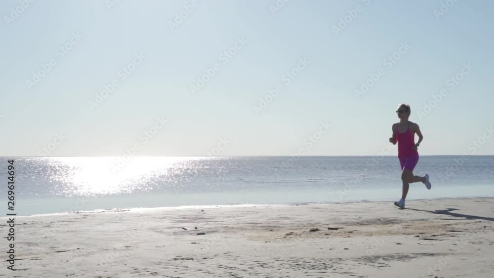 independent young woman athlete running on beach exercising female runner sprinting training in sunny seaside background independent young woman athlete running on beach exercising female runner sprinting training in sunny seaside background