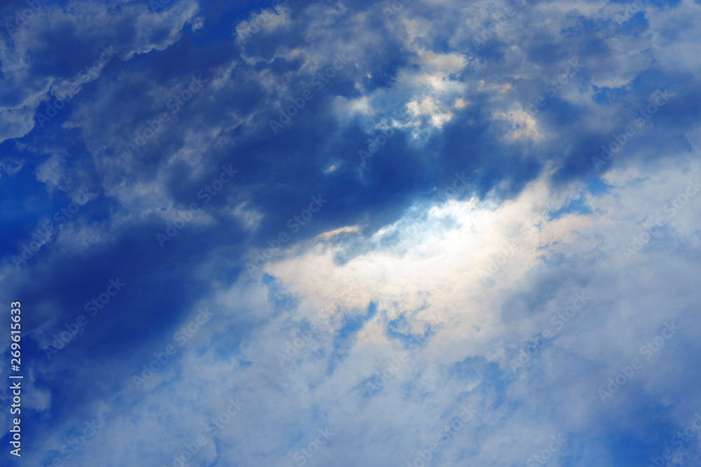 Stormy white clouds on blue sky. Cloudscape background