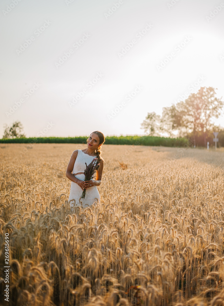 Bride portrait shooting in the field during the sunset time in the golden hour Bride portrait shooting in the field during the sunset time in the golden hour