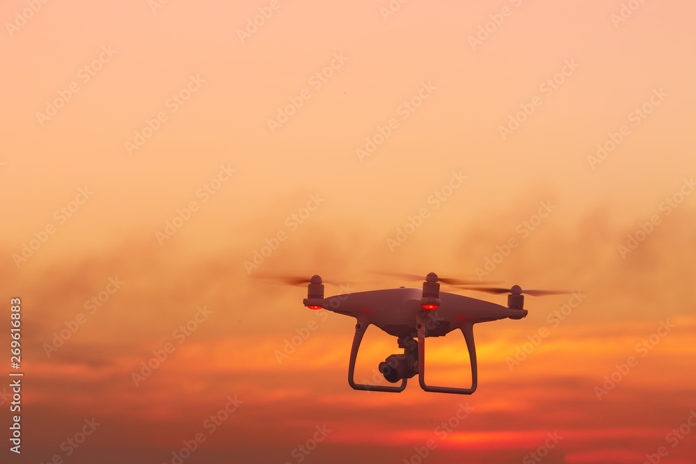 flying drone on the background of a beautiful sunset / beautiful sky drone doing its job flying drone on the background of a beautiful sunset / beautiful sky drone doing its job