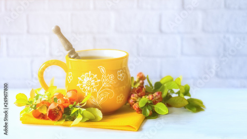 a cup of tea on a napkin in a cafe with branches of flowers. background with flowers and a Cup of tea. morning tea.