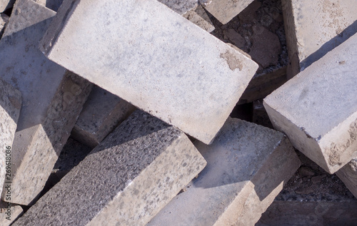 Pile of dirty gray curb bricks. background  texture.