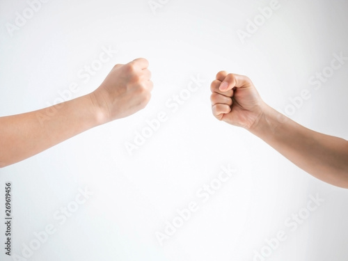 Two person playing rock paper scissors with both posturing rock or hammer symbol on white background. © jtas