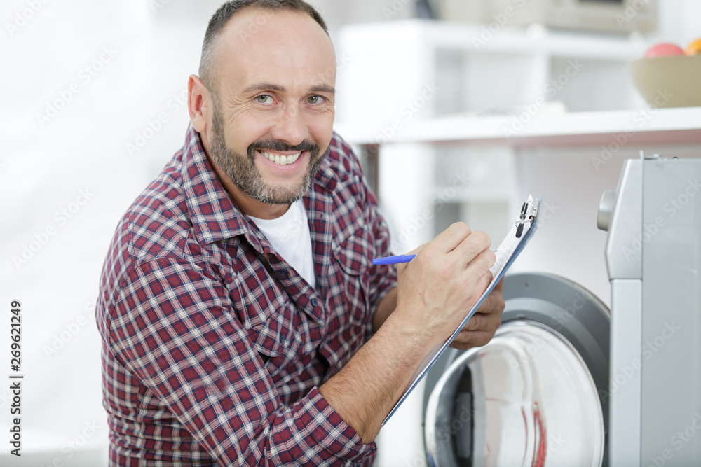happy man fixing washing machine