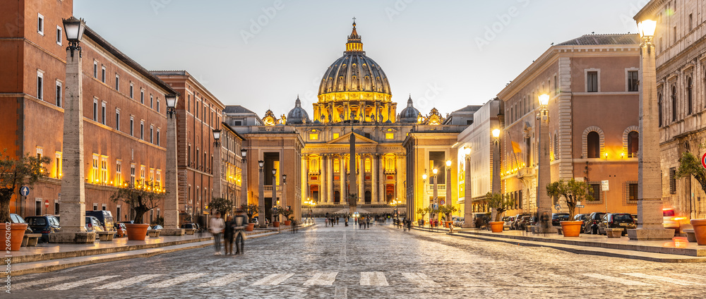 Vatican City by night. Illuminated dome of St Peters Basilica and St Peters Square at the end of Via della Conciliazione. Rome, Italy