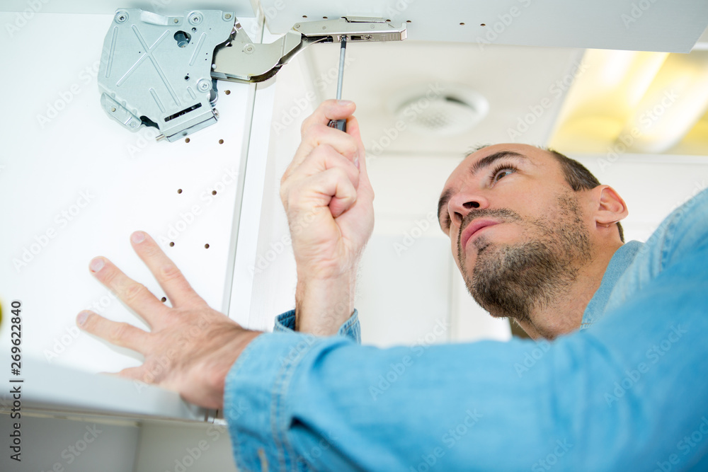 Obraz premium kitchen installer doing carpenter work