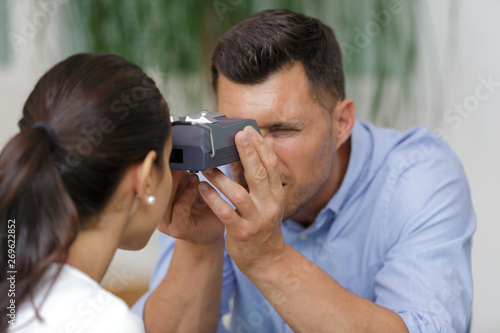 optometrist checking patient eyesight and vision correction