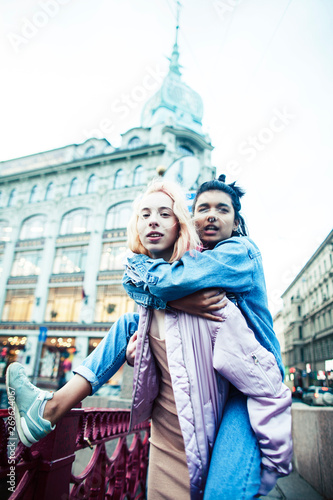 Two teenage girls infront of university building smiling, having fun, lifestyle real people concept close up