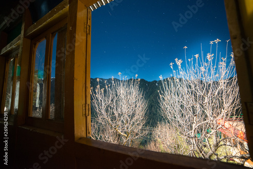 starry Sky view form the window of wooden hounse in himlayas - photo