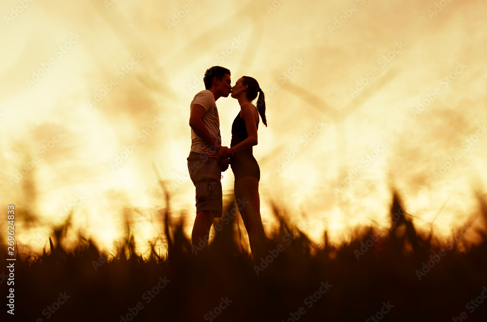 Fototapeta premium Couple kissing at sunset, people love and relationships 