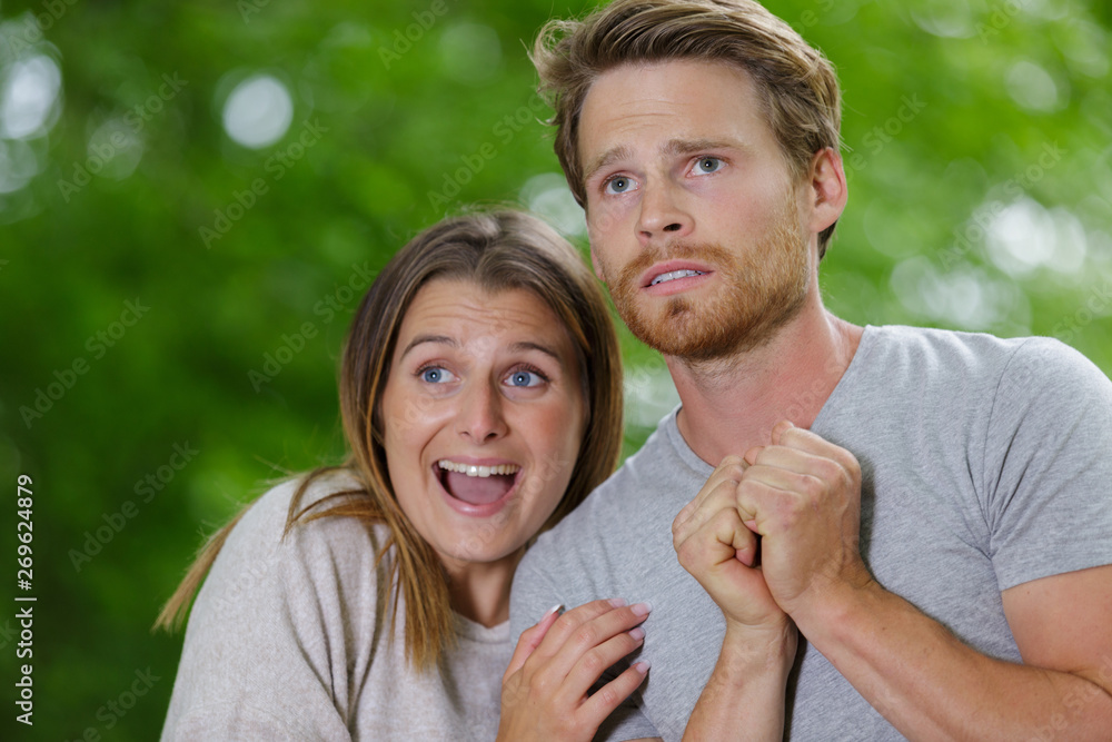 Fototapeta premium scared young couple in safari suits in jungle