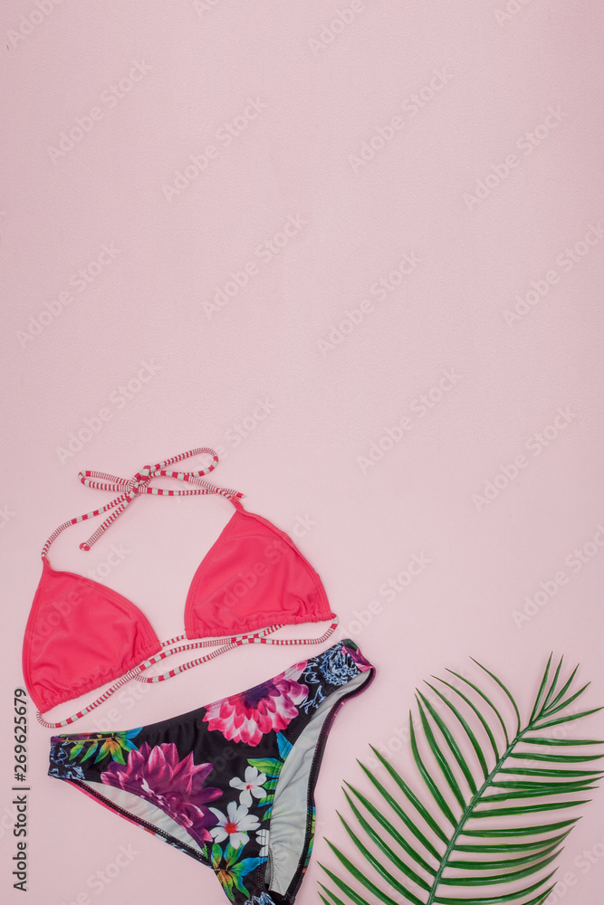 Hat, swimsuit and sunglasses on pink background. Top view, flat lay, space for text Hat, swimsuit and sunglasses on pink background. Top view, flat lay, space for text