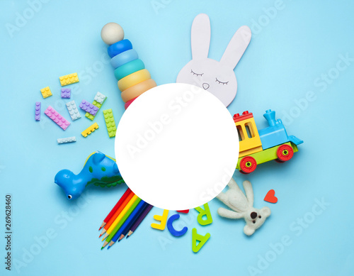 Kids toys on blue background with round copy space