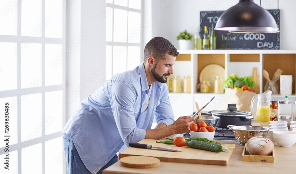 Smiling and confident chef standing in large kitchen Smiling and confident chef standing in large kitchen