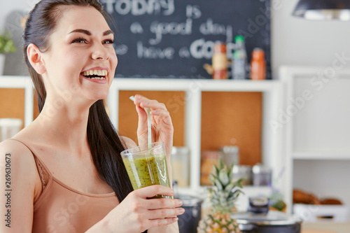 a young girl drinks a cocktail on a kitchen