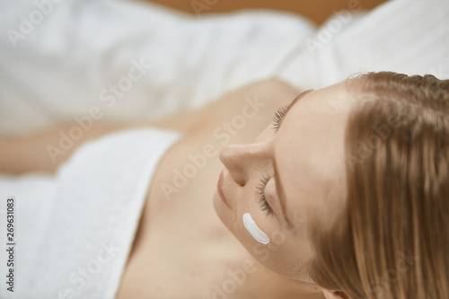 Beautiful young woman in cosmetic salon close up