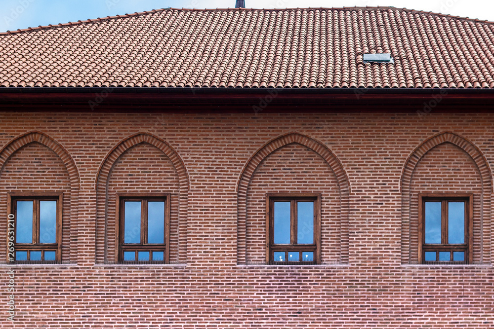 Front shoot of brick masonry structured old house under bright sky Front shoot of brick masonry structured old house under bright sky