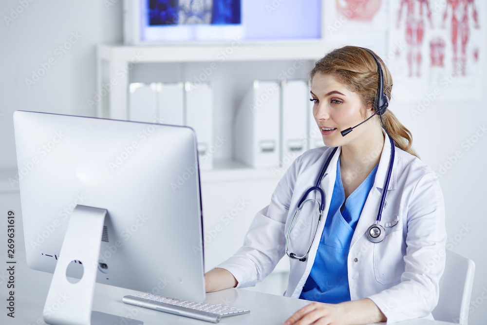 Portrait of a happy smiling young doctor in headset in office Portrait of a happy smiling young doctor in headset in office