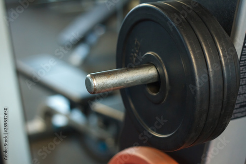 Close-up of a rod with weights in a gym, background or concept of weightlifting and sports