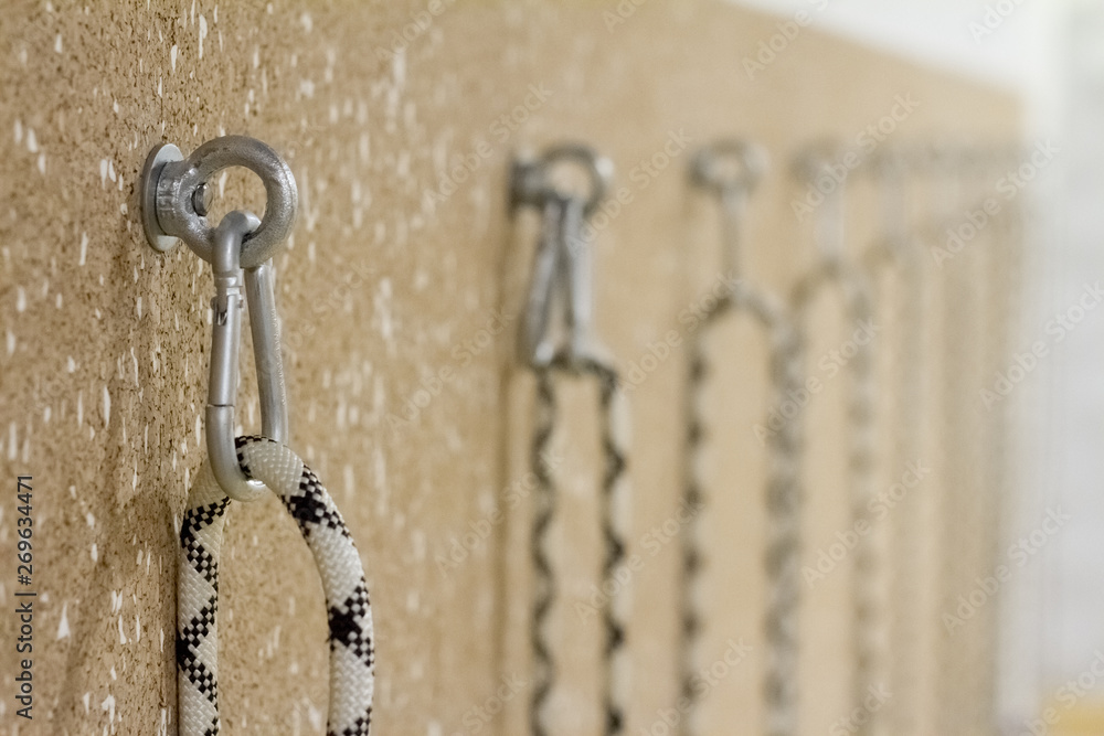 Close-up of staples and loops in the wall for stretching in a yoga studio Close-up of staples and loops in the wall for stretching in a yoga studio