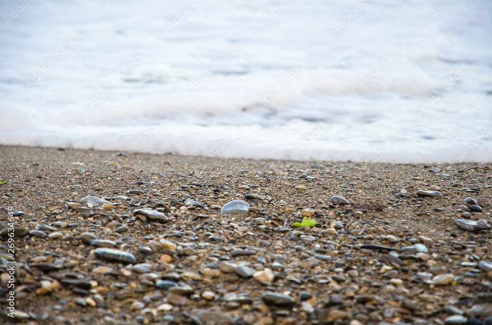 Background of seashore, pebble beach and sea close up Background of seashore, pebble beach and sea close up