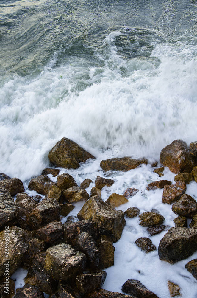 Seascape of dramatic storm, sea waves on wild rocky seashore