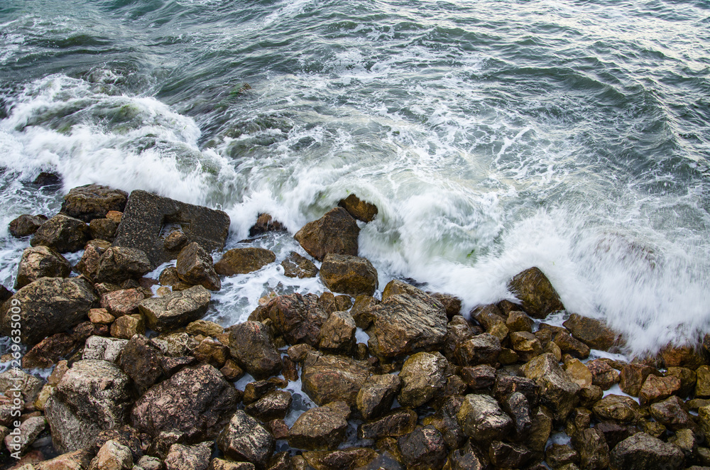 Seascape of dramatic storm, sea waves on wild rocky seashore Seascape of dramatic storm, sea waves on wild rocky seashore