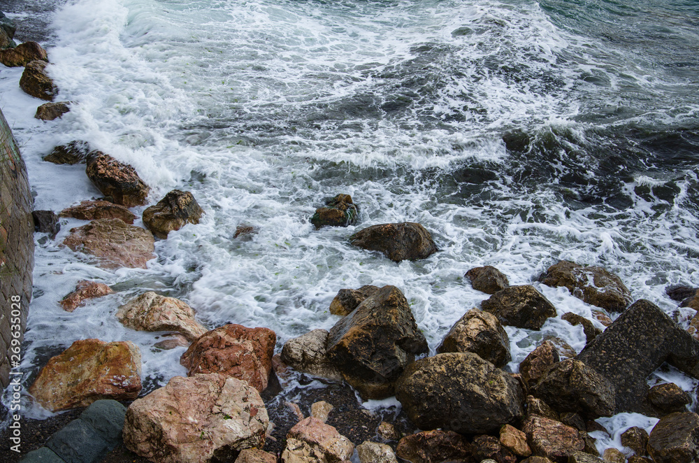 Seascape of dramatic storm, sea waves on wild rocky seashore