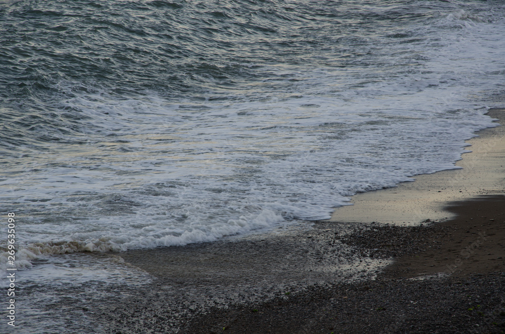 Seascape, view of beach and sea foam at sunset Seascape, view of beach and sea foam at sunset