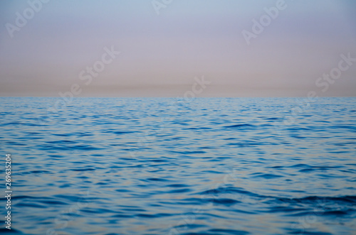 Seascape, view of sea horizon and colorful sky at sunset