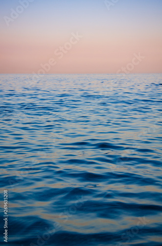 Seascape, view of sea horizon and colorful sky at sunset