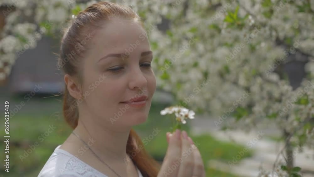 portrait of a woman in a beautiful blooming garden portrait of a woman in a beautiful blooming garden