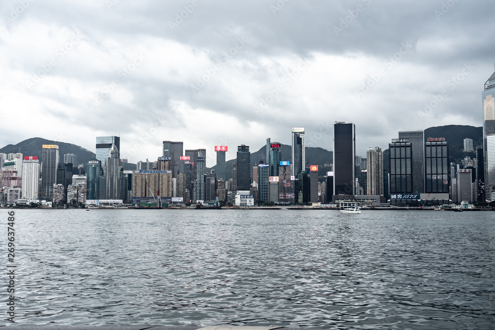 Naklejka premium Hong Kong / China - Feb 19 2019: Victoria harbour skyline panorama. Background skyscraper building of big city