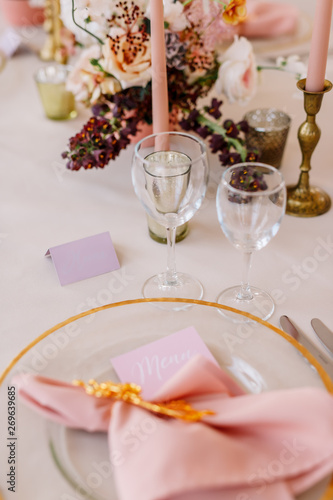 Wedding decoration table in the hall, floral arrangement. In the style vintage. Decorated dining table with flowers for guests and newlyweds, in peach-pink & pastel color. Beautiful table setting.