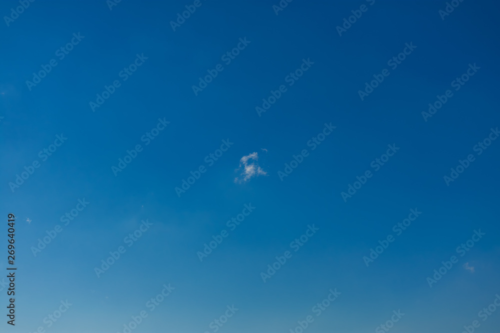 Fototapeta premium White cloud against blue sky. Single white cloud against a blue sky. White cloud blue sky.