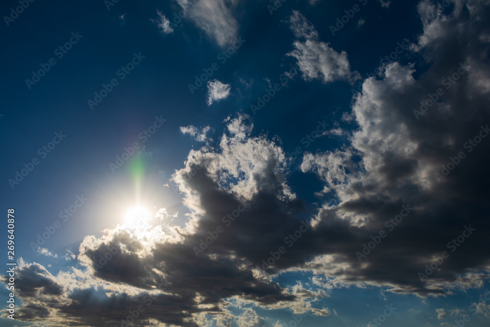 Obraz premium Clouds in bright sunlight. Nimbostratus clouds in sunlight. Blue sky and white clouds in bright sunlight.