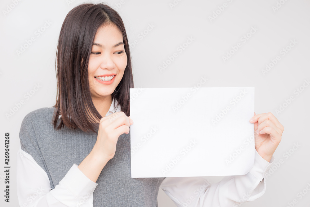Smiling business asian women hold blank white paper ads text sapce Smiling business asian women hold blank white paper ads text sapce
