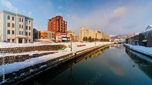 Wallpaper Mural Otaru Canal, Japan. Locked off timelapse. Winter cityscape, snow covered city, reflections in water. Sunny day. Torontodigital.ca