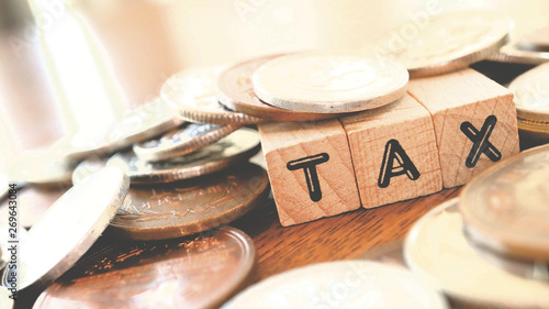 Text Block of "Tax" and Japanese Yen Coins on Table