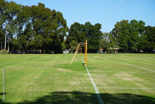 an empty green park with a soccer field