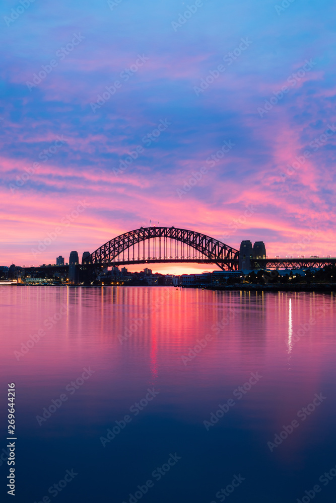 Fototapeta premium Silhouette of Sydney Harbour Bridge at dawn with blue and purple sky.