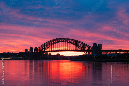 Silhouette of Sydney Harbour Bridge with colorful sky at dawn. © AlexandraDaryl