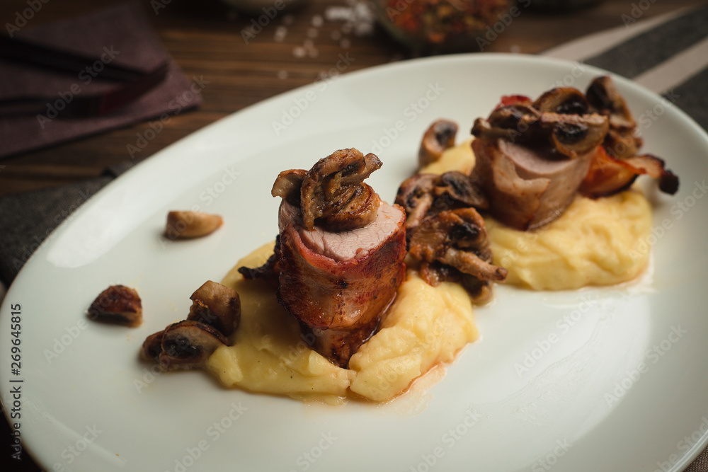 Pork neck with mushrooms and mashed potatoes. Cafe menu on a wooden background in warm colors with copy space.