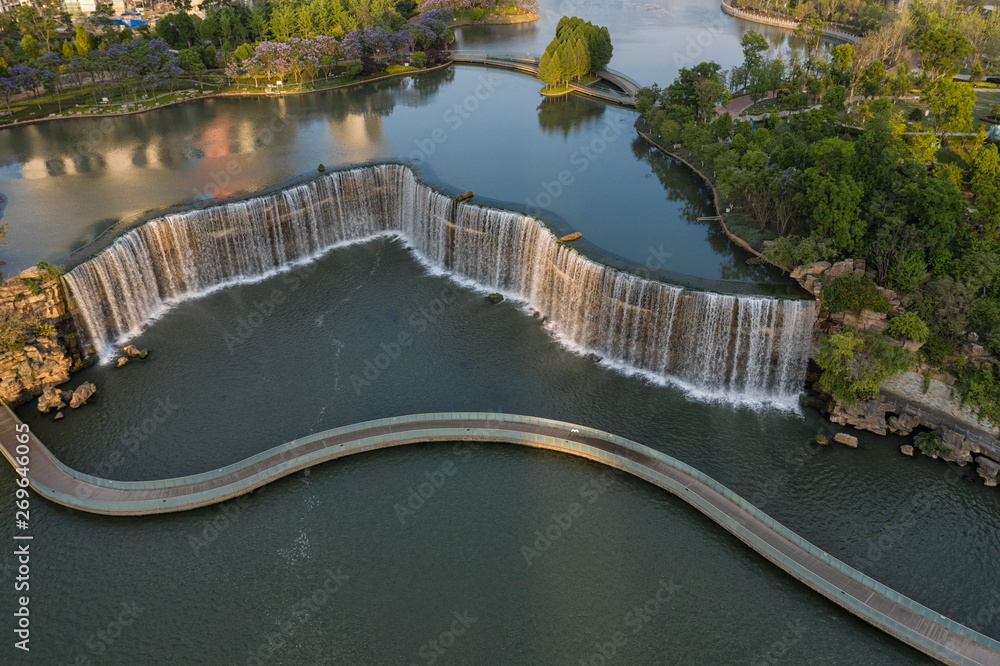 Aerial view of the Kunming Waterfall Park at sunset, one of the largest manamde waterfalls in the world