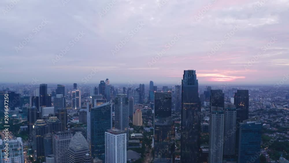 JAKARTA, Indonesia - May 23, 2019: Aerial view of silhouette of modern skyscrapers in Jakarta financial district at sunrise. Shot in 4k resolution from a drone flying upwards JAKARTA, Indonesia - May 23, 2019: Aerial view of silhouette of modern skyscrapers in Jakarta financial district at sunrise. Shot in 4k resolution from a drone flying upwards