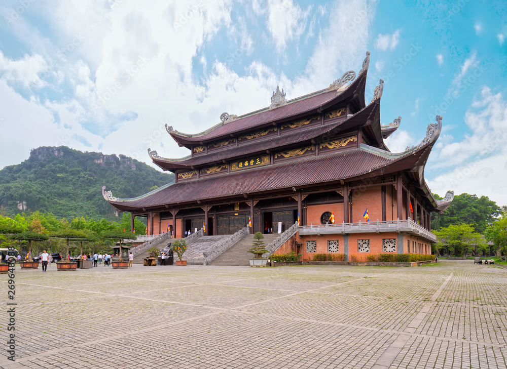 Fototapeta premium Ninh Binh, Vietnam - April 5th, 2019: Tam The Buddha's main architecture in Bai Dinh temple complex attracts tourists to visit, one of the largest in the south east asia in Ninh Binh, Vietnam